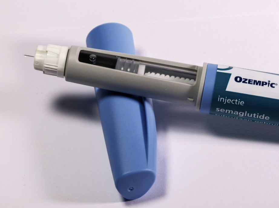 A GLP-1 injector sits on a table top.